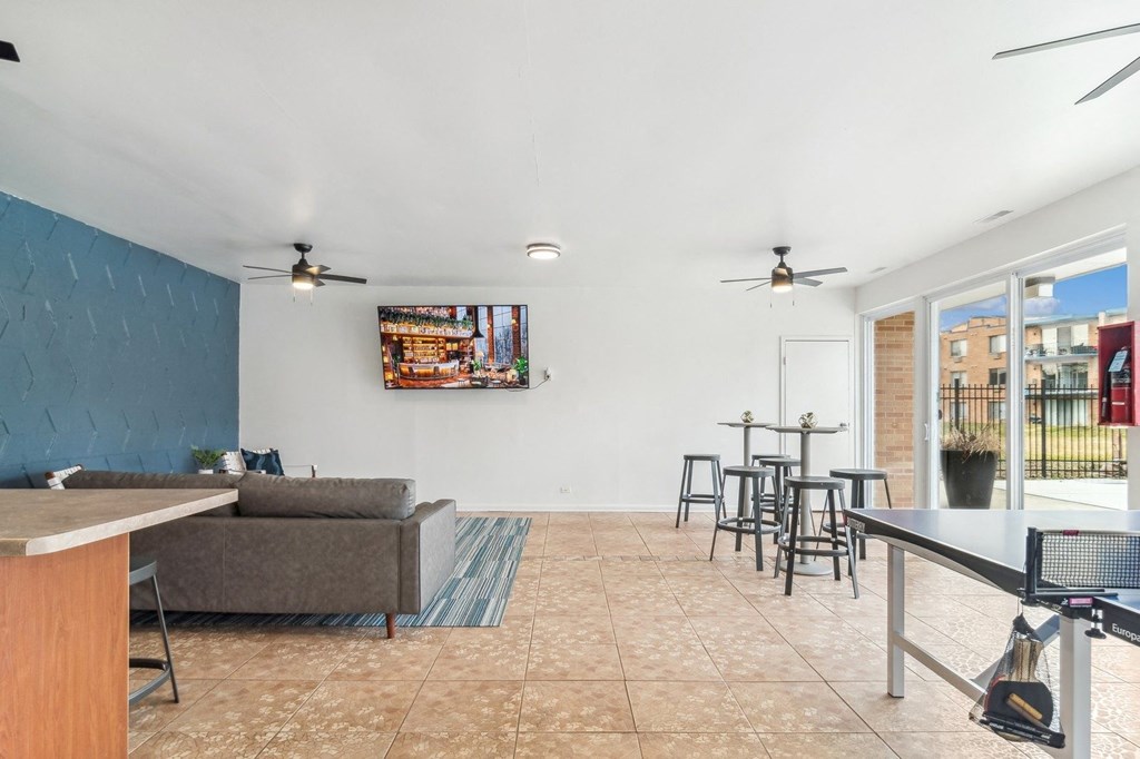 a living room with a couch and a table and chairs at The Reserve on Washington, Naperville, Illinois