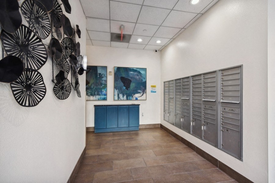 Mailroom at the gym with paintings on the wall