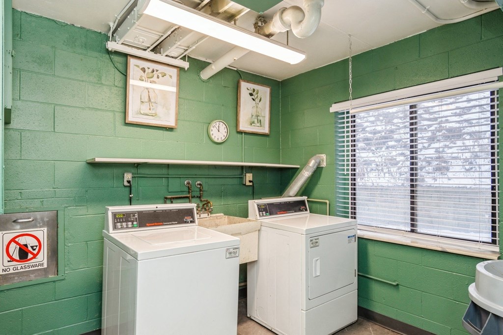 A laundry room with a washer and a dryer.