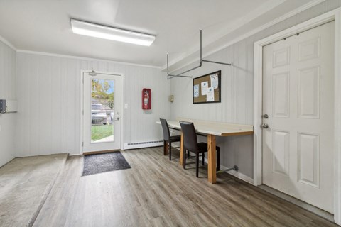 a dining room with a table and chairs and a door