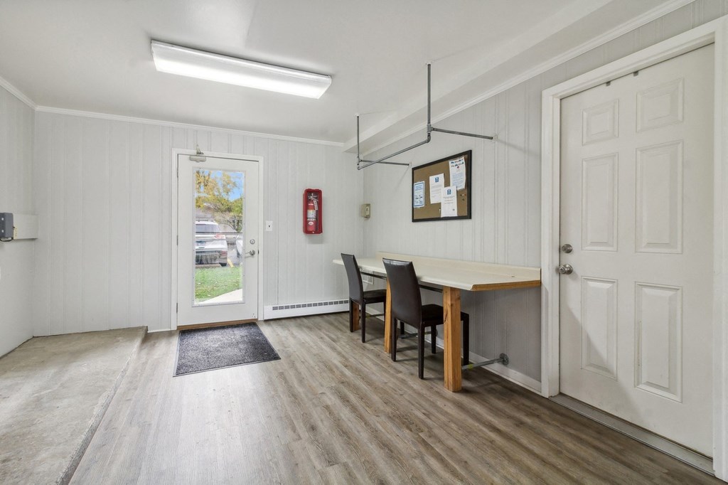 a dining room with a table and chairs and a door at River Oaks, Illinois