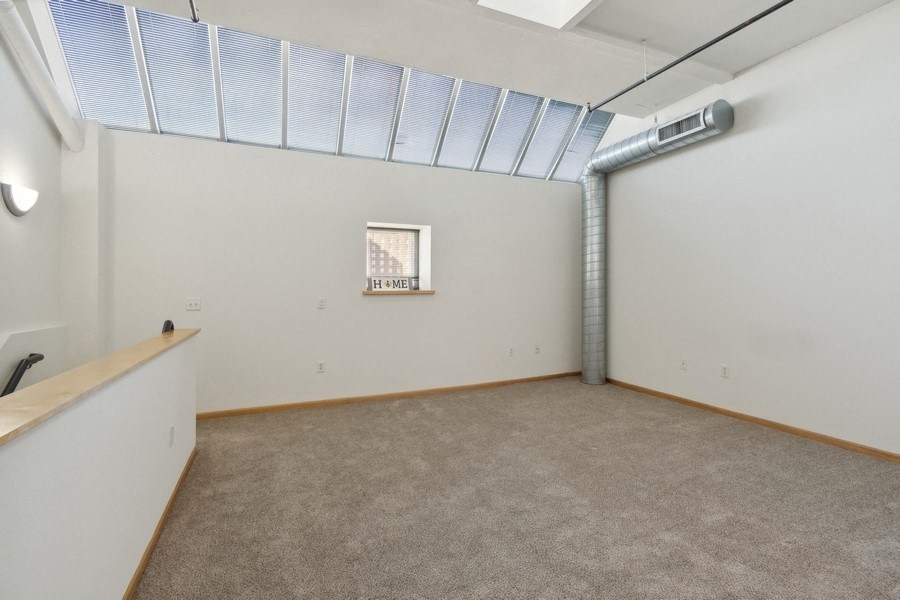 the living room is spacious and has a large window