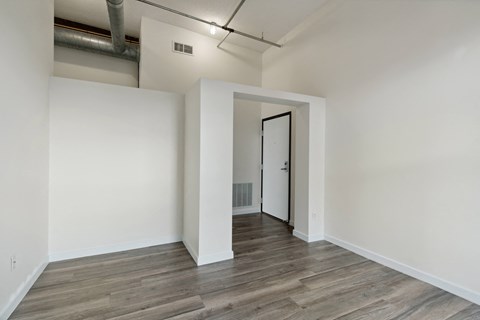 a bedroom with hardwood floors and white wallsat Gaar Scott Historic Lofts, Minnesota, 55401