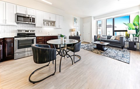 A modern kitchen with a dining table and chairs.
