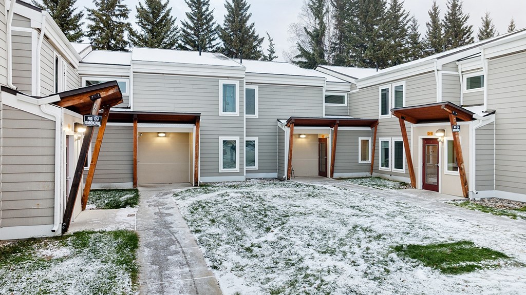 A row of houses with snow on the ground.
