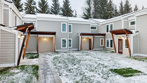 A row of houses with snow on the ground.