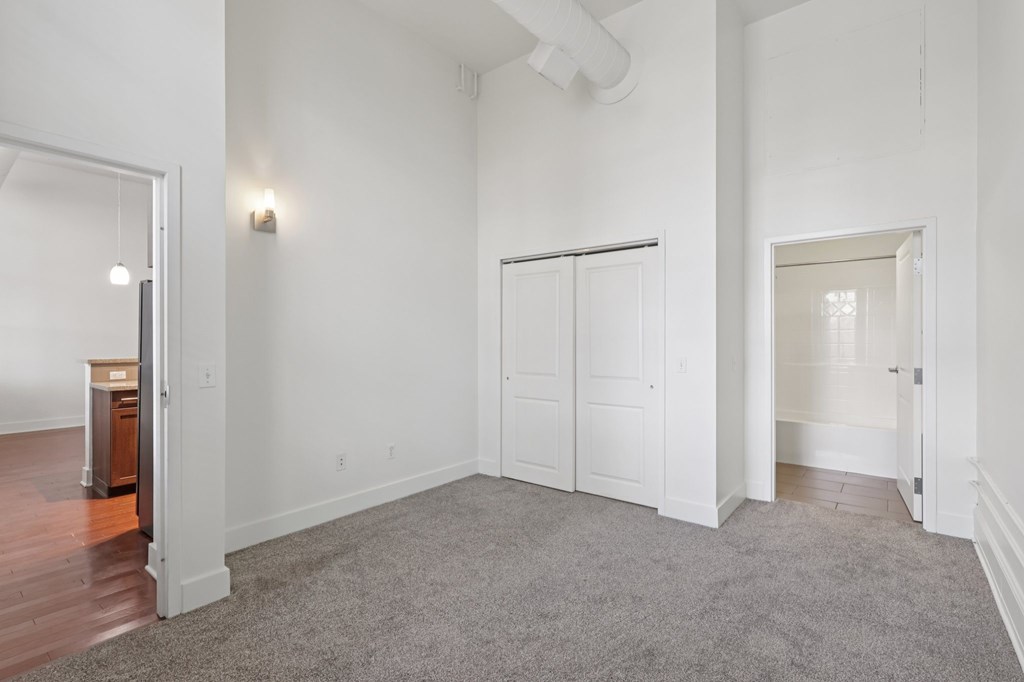A large room with white walls and a carpeted floor.
