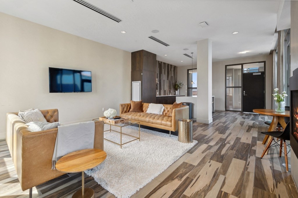 a living room with a couch and a tv at The Rowe, Grand Rapids