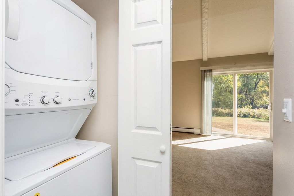 view from the laundry room into the living room with sliding room