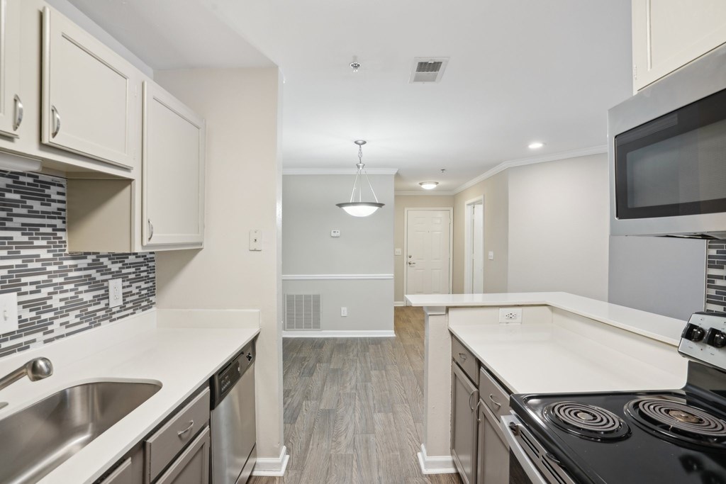 A kitchen with a stove top oven and a microwave.