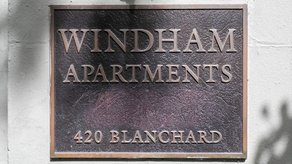 a sign for windham apartments on the side of a building