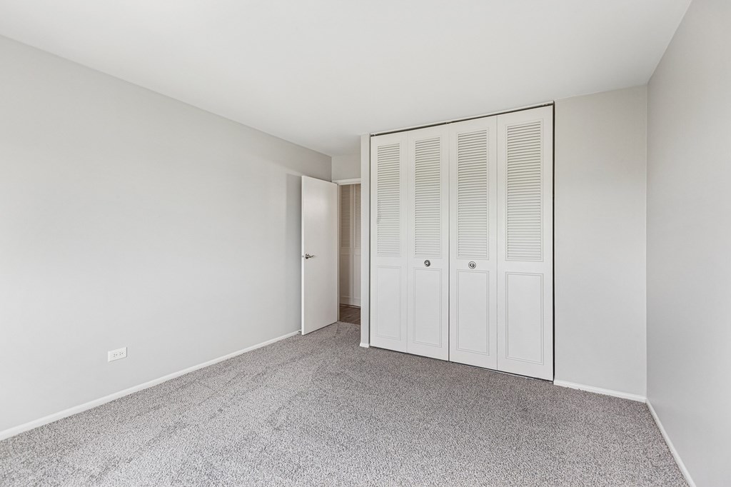 bedroom with carpet and closet doors