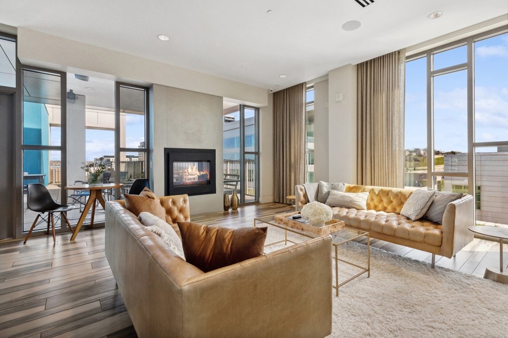 a living room with couches and a fireplace at The Rowe, Grand Rapids, 49503