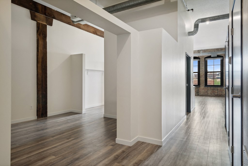 a large empty room with white walls and a wooden floor at Gaar Scott Historic Lofts, Minneapolis, Minnesota
