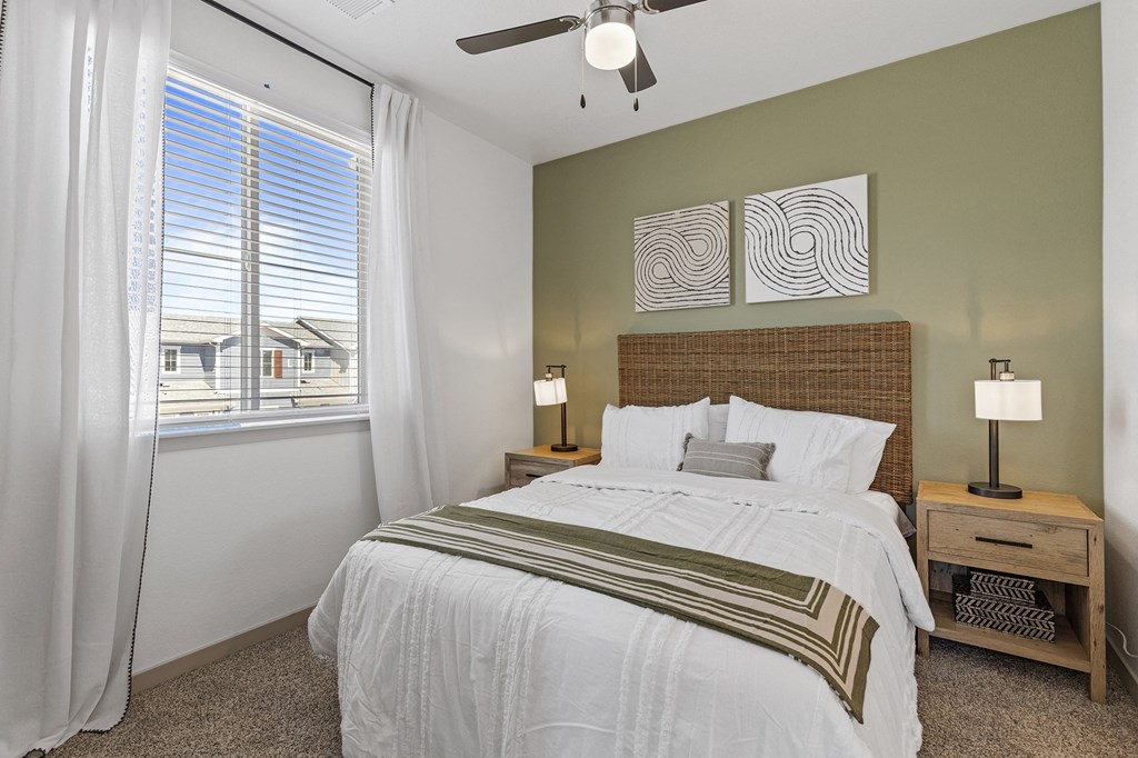 a bedroom with a large bed and a window