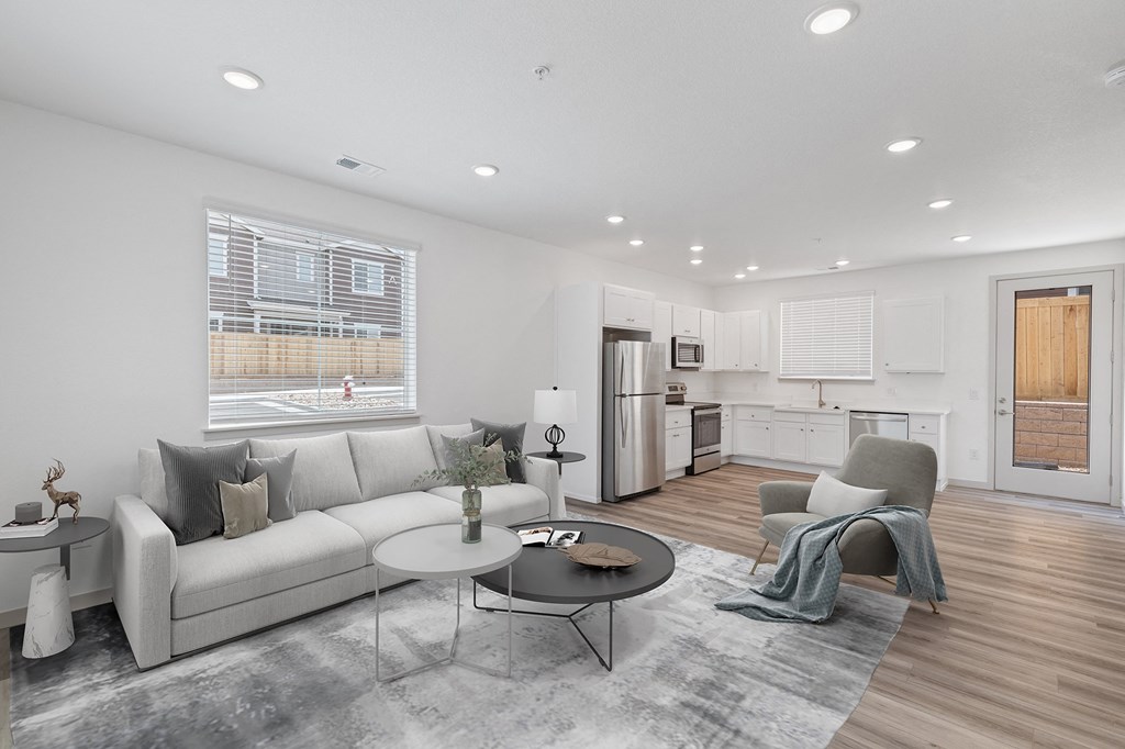 a living room with a couch and a chair and a table