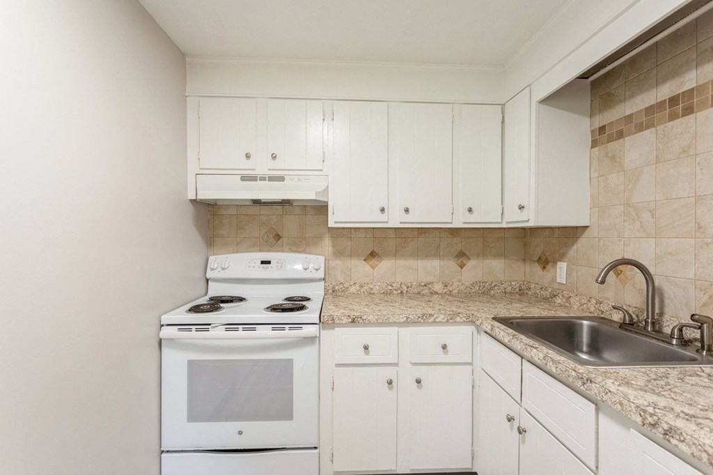 a white kitchen with white appliances and white cabinets at Stonebridge, Ellington, Connecticut