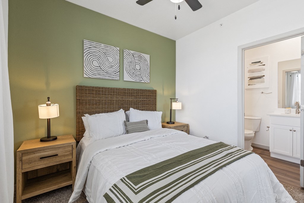 a bedroom with a large bed and a bathroom with a toilet