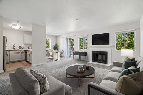 A modern living room with a grey couch and a coffee table.