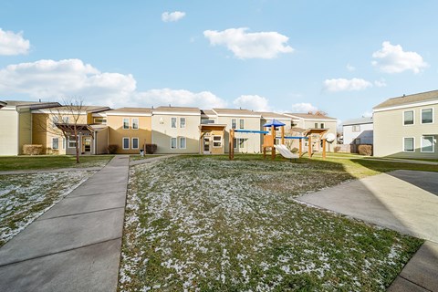 A residential area with houses and a playground.