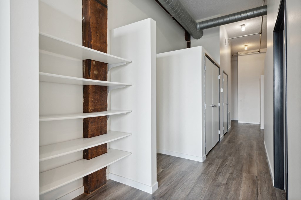 a walk in closet with white walls and wooden shelvesat Gaar Scott Historic Lofts, Minneapolis, MN, 55401