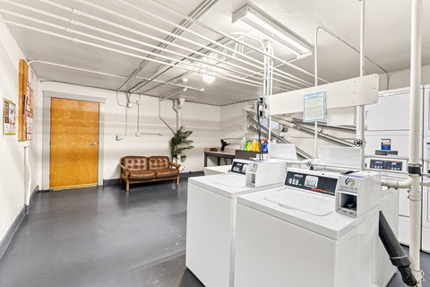 Community laundry room with modern machines at Forestry Court Apartments, Portland, Oregon
