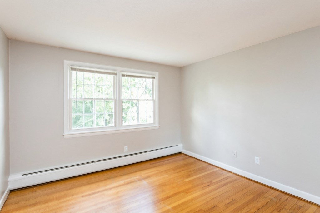 Empty room with hardwood floors and a window