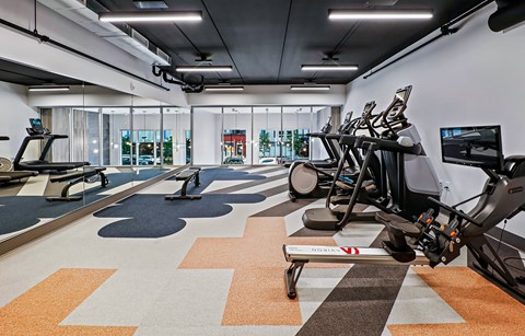 Fitness center with cardio machines and rowing equipment at Pure Lowry Apartments, Minneapolis, Minnesota