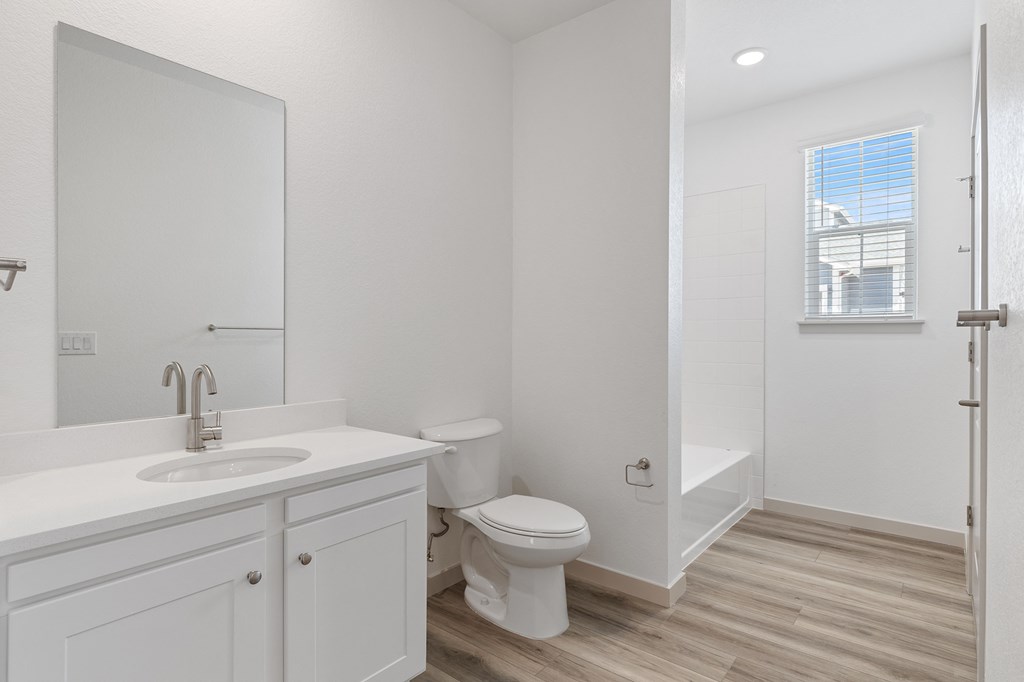 an empty bathroom with a toilet and a sink