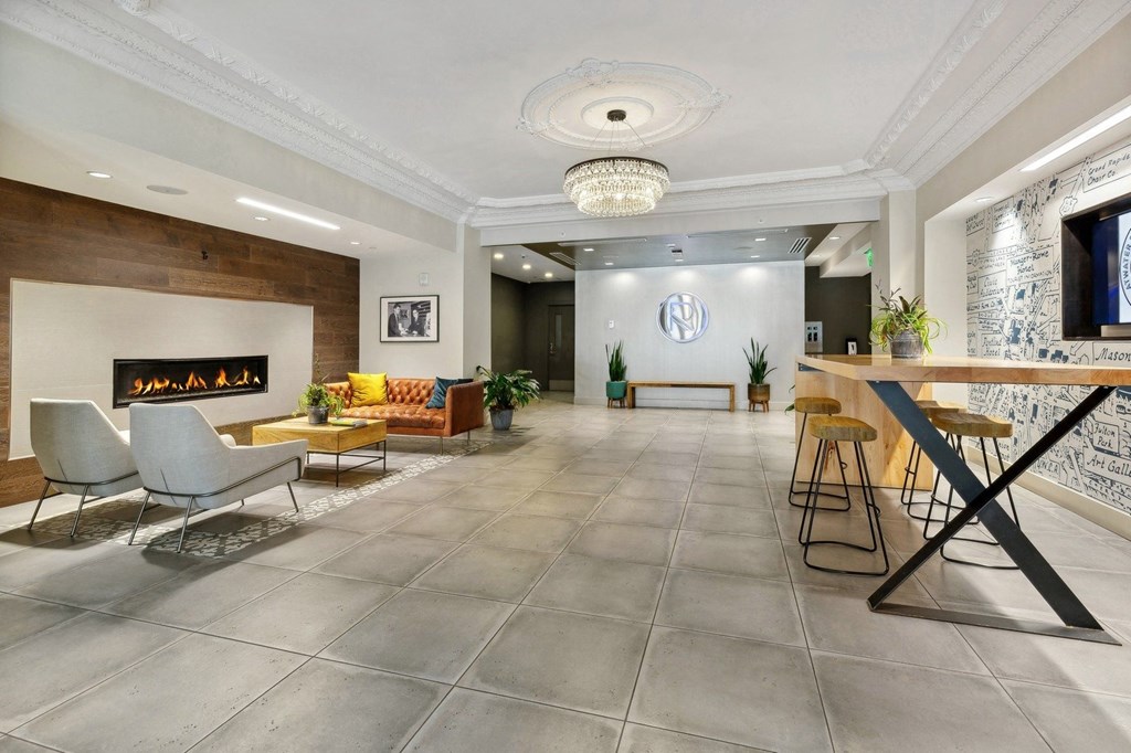 a living room with a fireplace and a table with chairs at The Rowe, Michigan