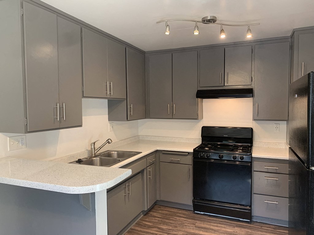 a kitchen with stainless steel appliances and white counter tops