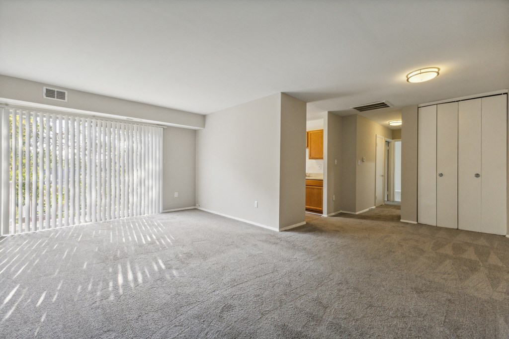 an empty living room with white walls and a large window at Briarwood Apartments, Virginia, 22026