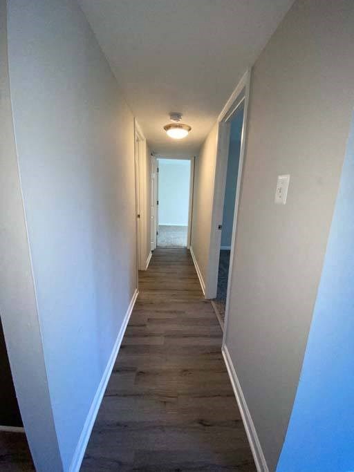 a hallway with a wooden floor and a light on the ceiling at ReNew Odenton, Maryland, 21113