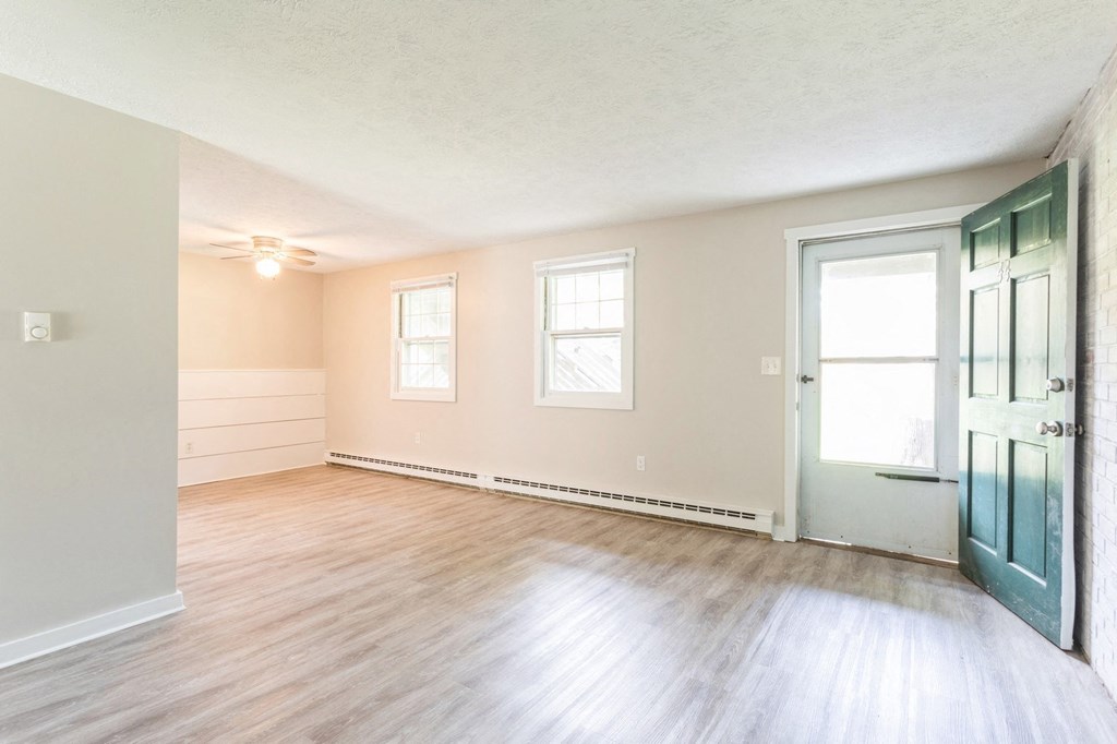 living room with wood floors and a green door at Stonebridge, Connecticut, 06029