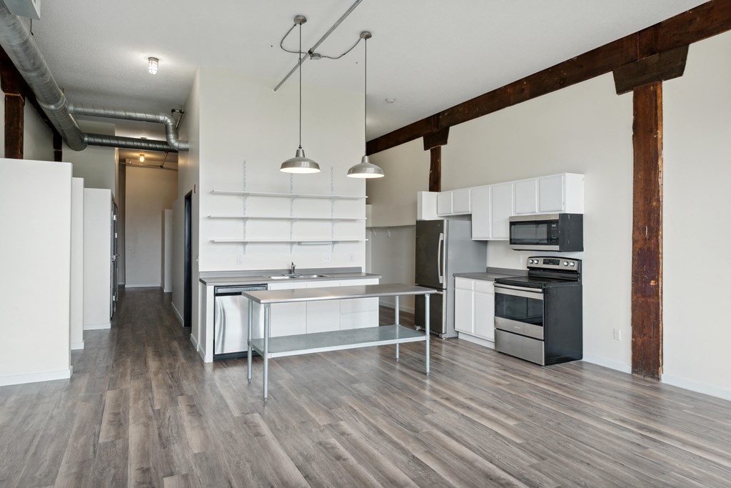 a kitchen and dining area in a 555 waverly unitat Gaar Scott Historic Lofts, Minnesota, 55401