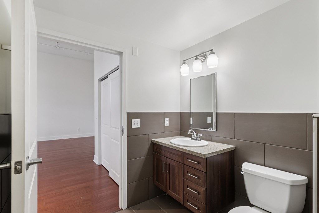 A bathroom with a white toilet and a white sink.