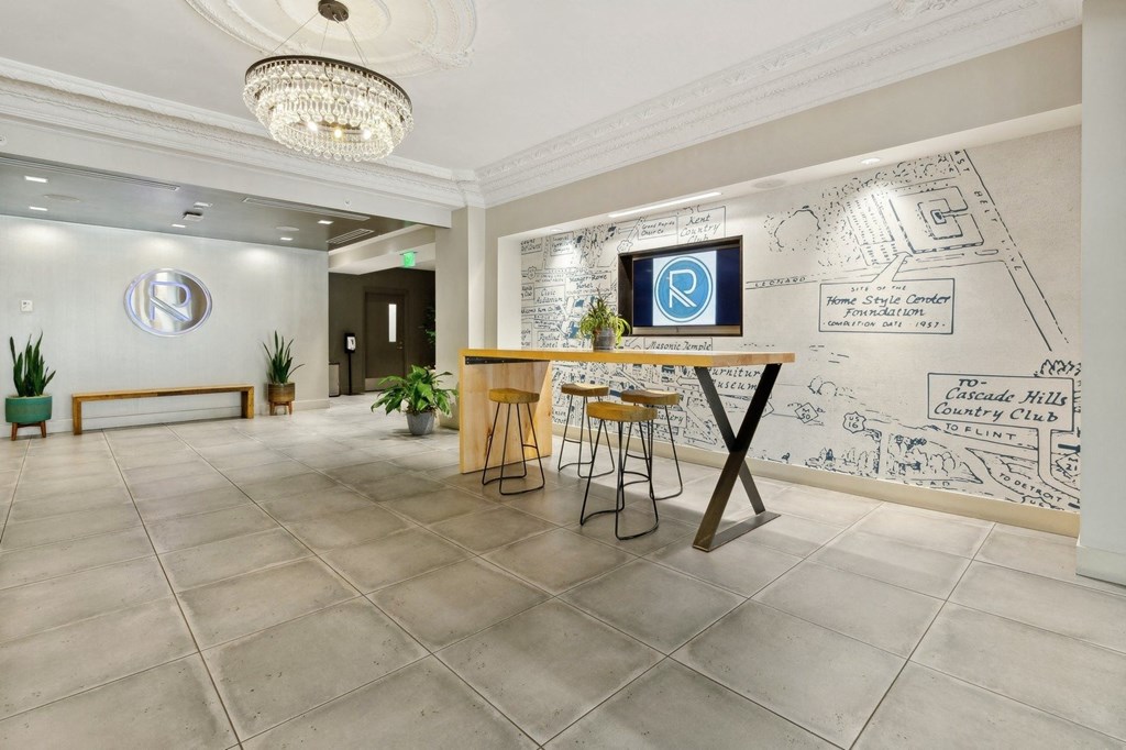 the lobby of a restaurant with a bar and graffiti on the wall at The Rowe, Grand Rapids, MI