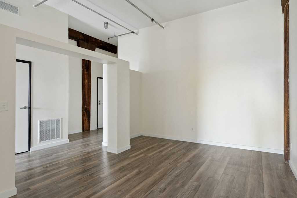 an empty room with hardwood floors and white wallsat Gaar Scott Historic Lofts, Minneapolis, Minnesota