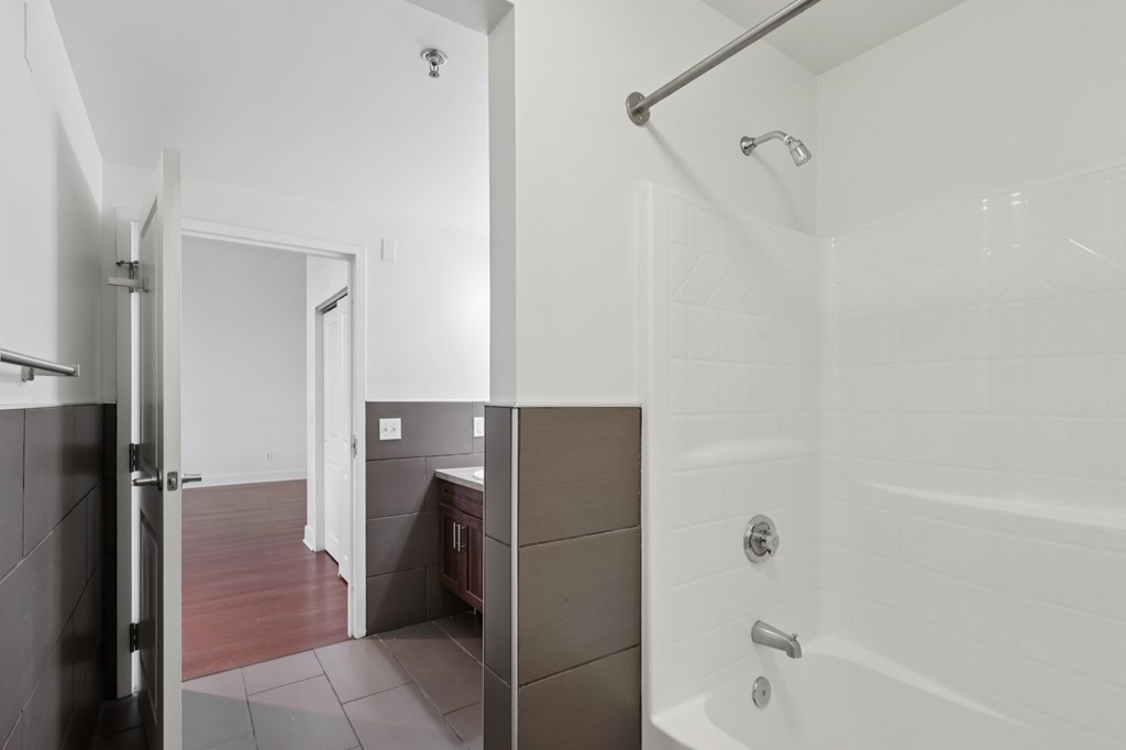 A white bathroom with a bathtub and shower.