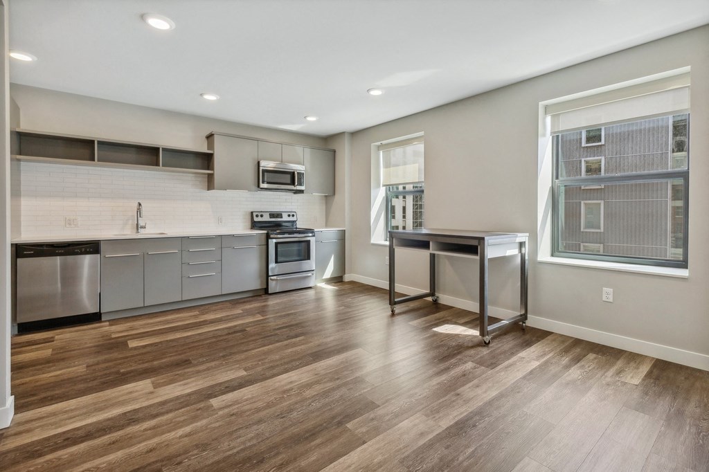 an open kitchen with stainless steel appliances and a window at The Rowe, Michigan