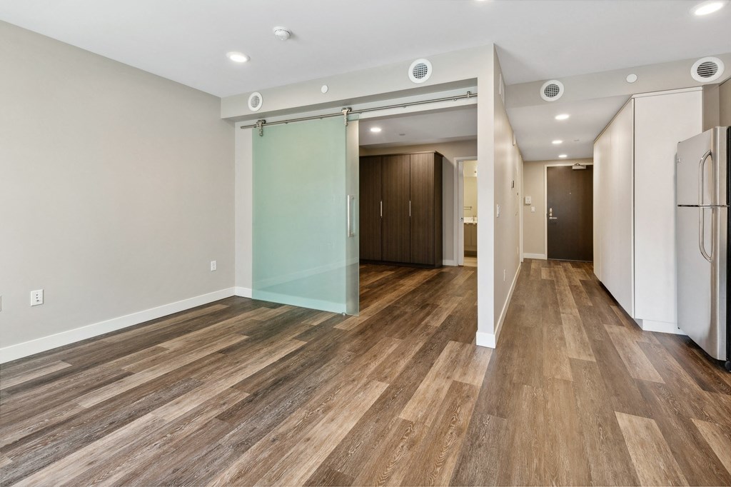 a living room with white walls and a sliding glass door at The Rowe, Michigan