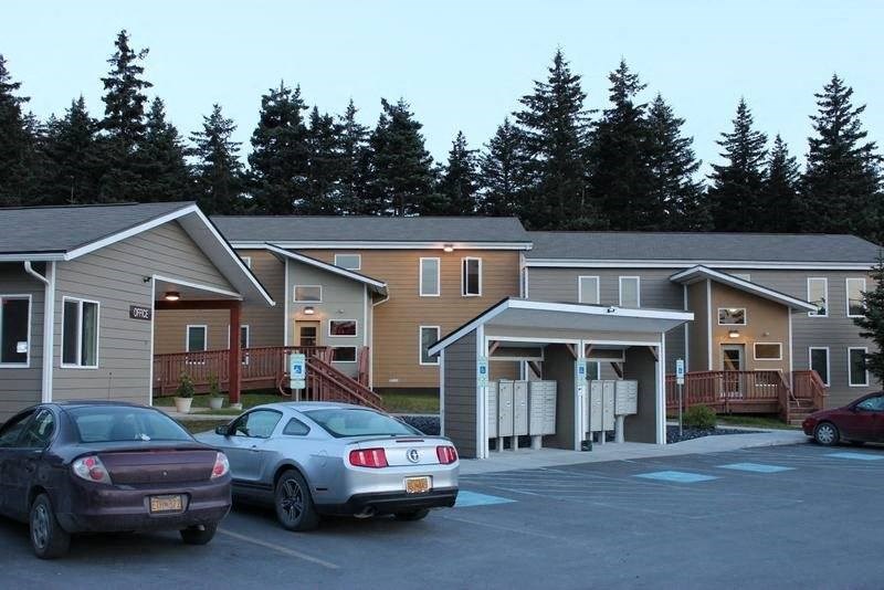 a parking lot filled with cars at Fir Terrace Apartments, Kodiak