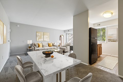 A modern dining room with a marble table and chairs.