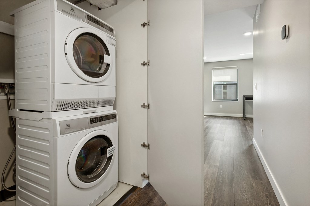 a washer and dryer stacked on top of each other in a laundry room at The Rowe, Grand Rapids, Michigan