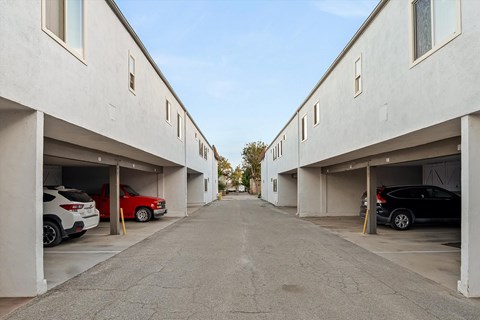 Covered parking garages along central driveway at Shorehaven Townhomes Apartments, California