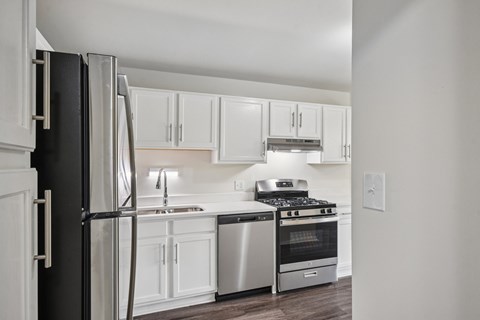 A kitchen with white cabinets and stainless steel appliances.