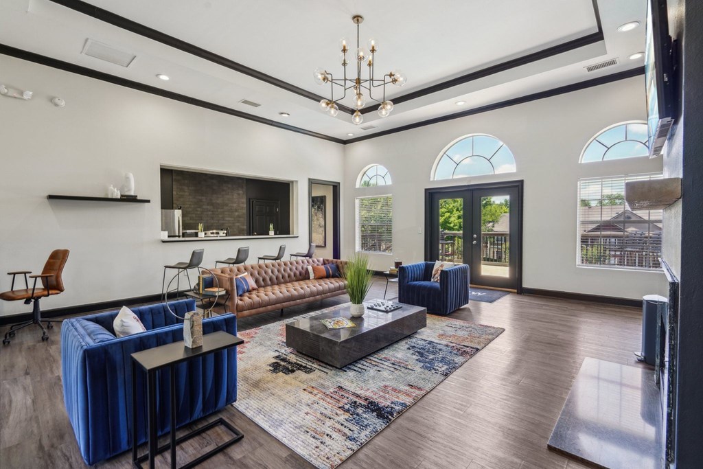 A living room with a blue sofa and a wooden floor.