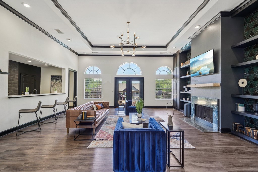 Community room with a blue table and a fireplace.