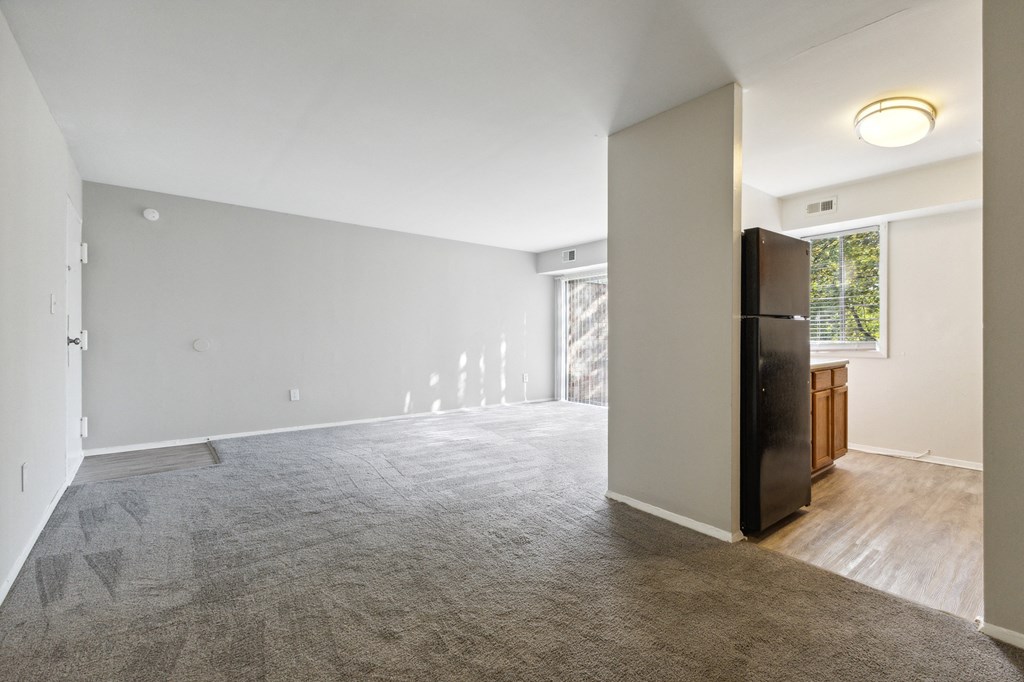 an empty living room with a refrigerator and a window at Briarwood Apartments, Dumfries