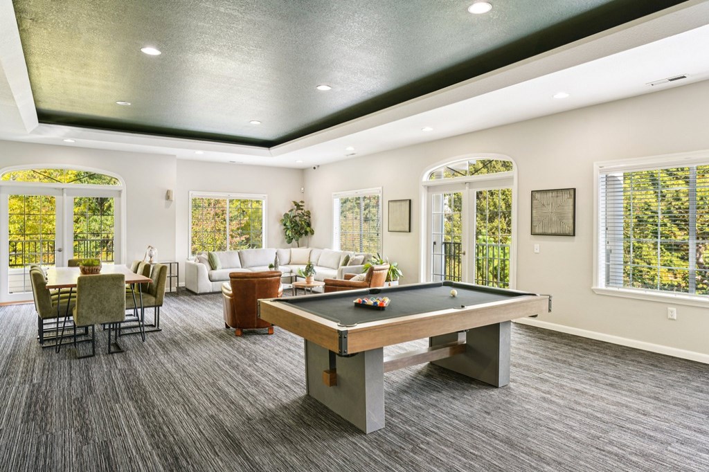 Clubhouse with a pool table and chairs